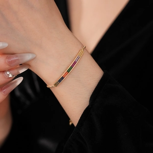 Detail of adjustable gold bracelet with gradient rectangle-cut colorful cubic zirconia