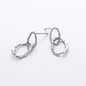 Detailed macro view of S925 sterling silver interlocking double hoop dangle earrings
