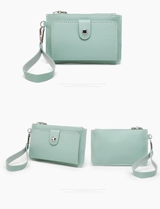 Detailed view of mint green coin purse with lychee grain leather and wrist strap