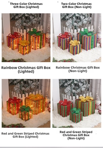 Lighted Christmas gift box set in rainbow and red stripes with glowing LED warm light