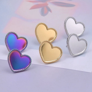 Detailed view of heart stud earrings in gradient purple, gold, and silver finishes