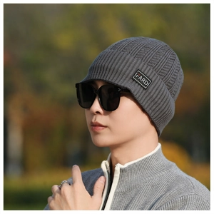 Detail of dark grey ribbed knit beanie featuring an embroidered FARD side letter label