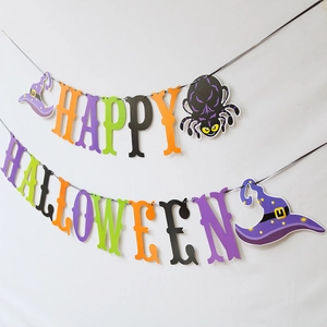 Detailed view of Happy Halloween paper banner with purple spider and green witch hat