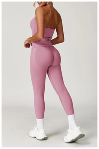 Rear view of pink seamless racerback sports top and high-waist leggings on model