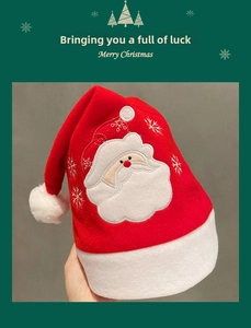 Detail of plush Santa Claus hat featuring snowflake embroidery and soft velvet texture