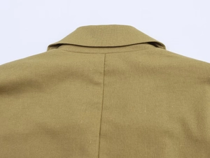 Detailed close-up of khaki linen blend double-breasted blazer lapels and fabric texture