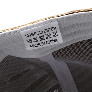Close-up of baseball cap interior showing white mesh lining and polyester material label
