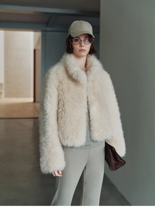 Close-up of the fluffy cream faux fur texture on the stylish stand-collar winter vest