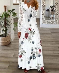 Close-up of white lace long dress with V-neck, buttons, and colorful floral print details