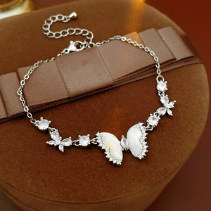 Detailed shot of resin butterfly bracelet with zircon accents on brown velvet box