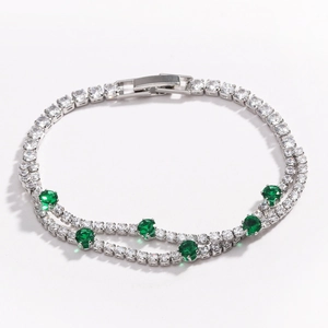 Detail of double-layer silver tennis bracelet with white and green round cubic zirconia