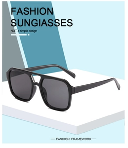 Detail view of black square double bridge sunglasses on geometric display stand