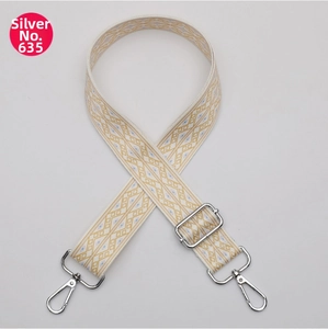 Detail of adjustable bohemian bag strap with diamond pattern and silver metal hardware