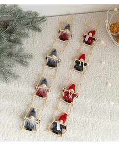 Felt Santa Claus climbing a wooden ladder ornament with festive knitted outfits details