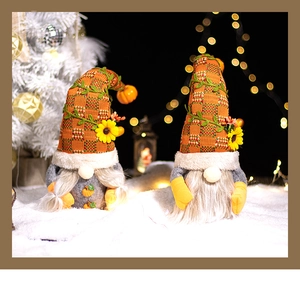 Detailed view of handmade fall harvest gnomes with orange plaid hats and sunflower accents