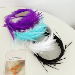 Detailed view of colorful feather headbands in purple, cyan, white and black colors