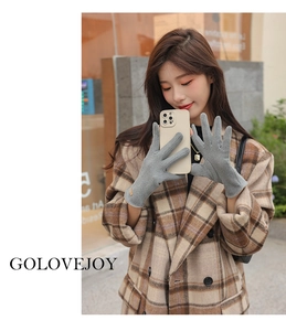 Detail view of grey knit thermal glove with leather logo patch and touchscreen feature