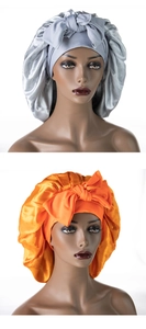 Detail showing high-gloss satin sleep bonnet with wide headband and large decorative bow