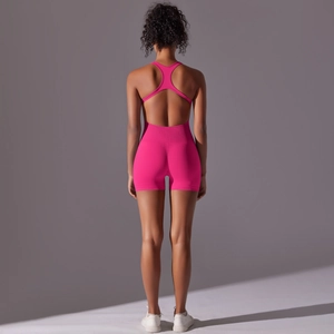 Detail of rose red seamless yoga romper featuring a hollow out racerback design