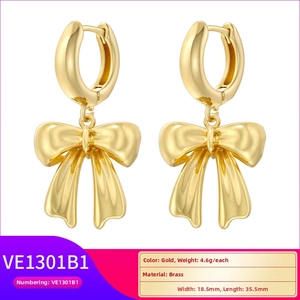 Detail view of 18.5mm x 35.5mm gold bow earrings in brass with 4.6g weight specs
