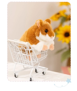 Cute brown hamster plush toy sitting in a mini shopping cart with soft sunflower background