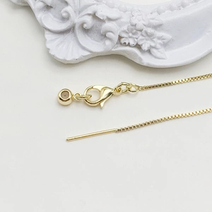 Detail of adjustable 14k gold chain with lobster clasp and needle end for DIY jewelry