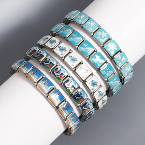 Silver stainless steel Italian charm bracelet with nautical enamel charms on white stand