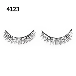 Detail of cross-woven black false eyelashes with natural volume on a white background