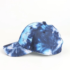 Detailed side view of blue and white tie-dye baseball cap with curved brim and panels