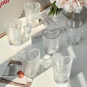 Set of heart-shaped glass cups with ribbed textures and elegant gold rim details
