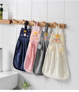 Detail of four hanging pig-shaped hand towels in coral fleece for kitchen and bathroom
