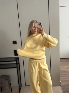 Cozy lemon yellow knit tracksuit set featuring a crewneck sweater and drawstring wide-leg pants