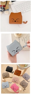 Close-up of cute cat-shaped leather coin purses featuring embroidered faces and cat tail zippers