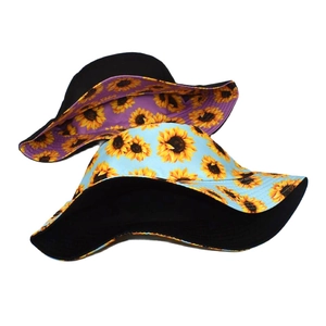Detail showing reversible bucket hats with sunflower prints in blue and black colors
