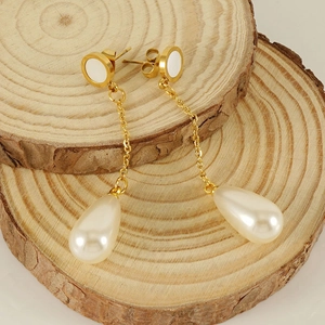 Elegant 18K gold-plated stainless steel pearl drop earrings on natural wood decor