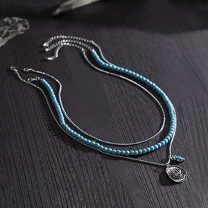 Western cowboy hat pendant necklace with turquoise beads layered design on wood