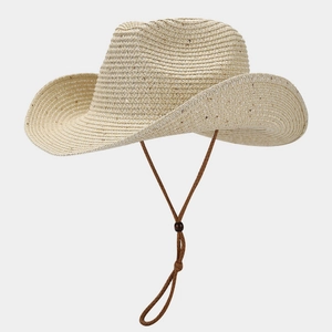 Detail of hand-woven straw panama hat featuring adjustable brown chin strap and texture