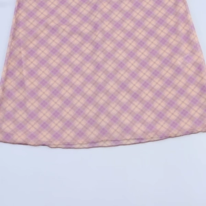 Gros plan détaillé du tissu en maille à carreaux violets et jaunes avec couture fine
