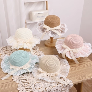 Detail of girls' straw hats featuring lace brim and ribbons in five assorted colors