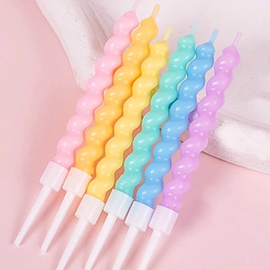 Macro detail of six colorful spiral birthday candles with white plastic holders
