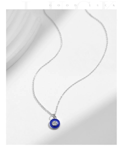 Macro shot of S925 silver Evil Eye pendant with blue enamel and sparkling cubic zirconia