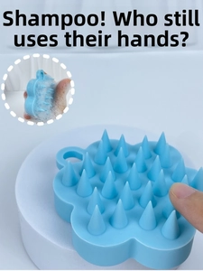 Sky blue flower-shaped silicone scalp massager brush with hanging hole and tapered bristles
