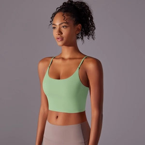 Close-up of thin straps and U-neck detail on a light green seamless yoga sports bra
