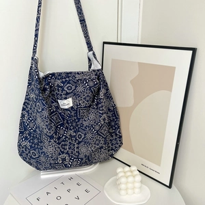 Detailed close-up of blue paisley fabric tote bag with aesthetic lifestyle decor