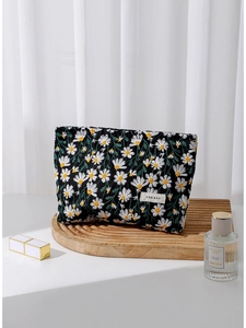 Gesteppte schwarze Baumwoll-Kosmetiktasche mit Gänseblümchen-Stickerei und Label