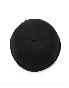 Top-down view of a black six-panel cotton brimless docker cap with fabric top button