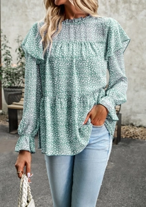 Detail of green floral blouse featuring ruffle high neck and leopard print patterns