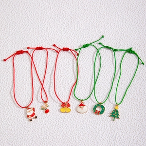 Detail view of adjustable Christmas bracelets with colorful enamel charms on braided cords
