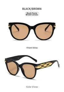 Detail of black oval sunglasses featuring gold geometric metal accents on wide temples