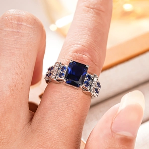 Macro shot of rectangular blue gemstone set in a vintage four-prong silver ring